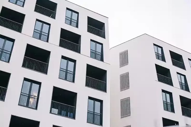 White apartment buildings against the sky
